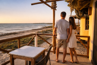 "A couple enjoying the ocean view from the private terrace of a luxury oceanfront cabin in Magdalena Bay, Baja California Sur."